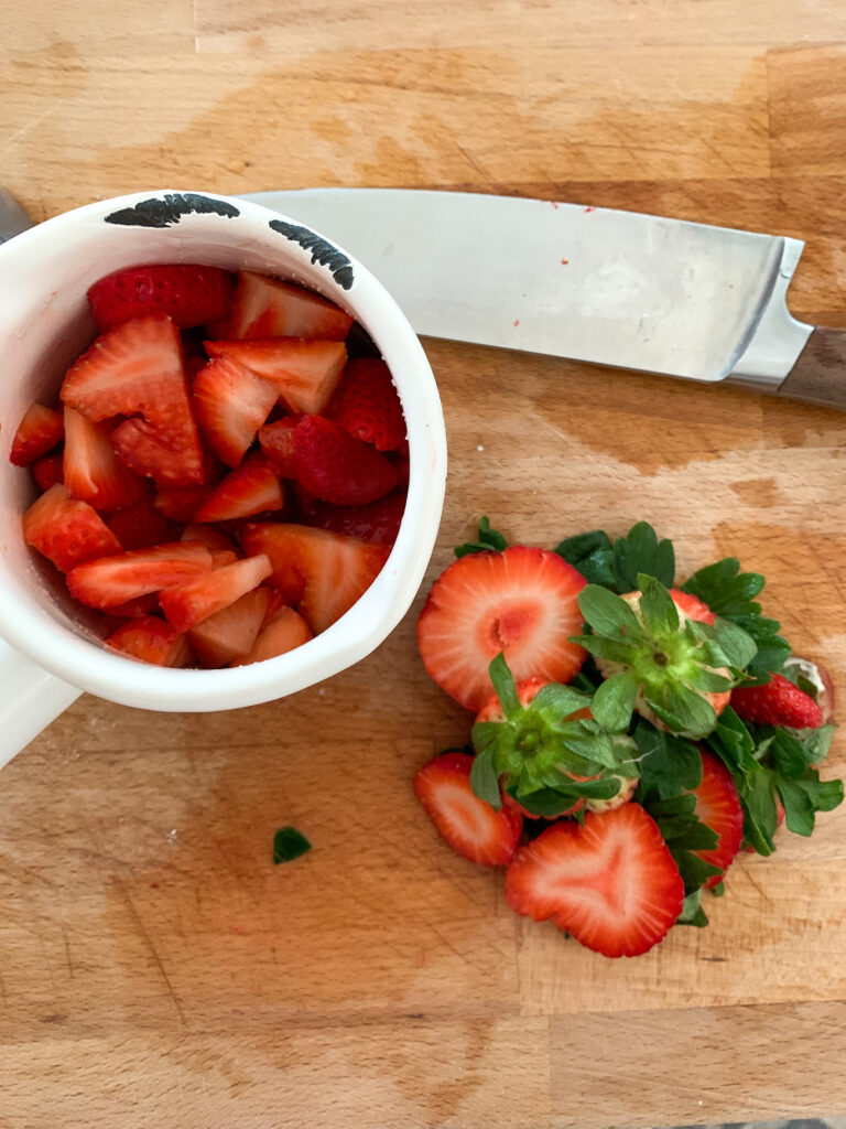 strawberries on cutting board with knife