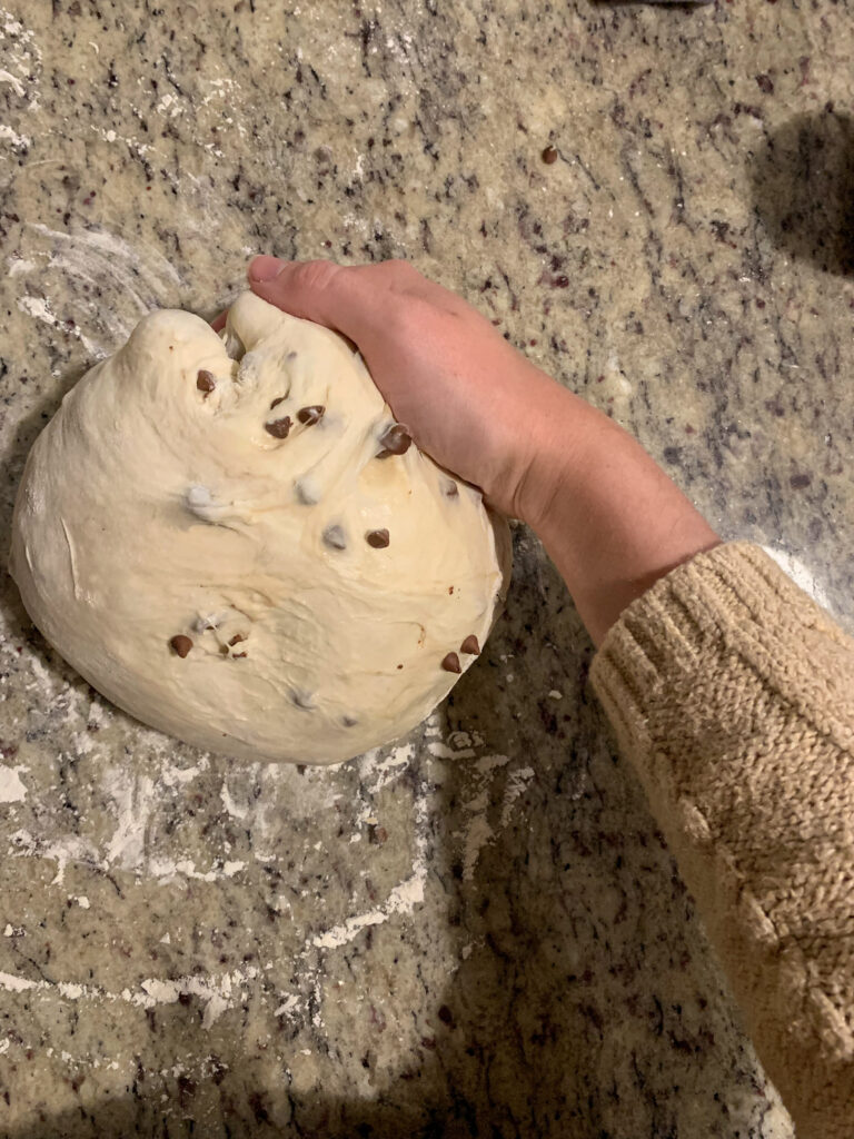 Chocolate chip sourdough being shaped by hand